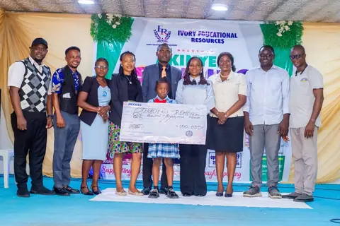 Winner receiving the grand prize cheque with dignitaries