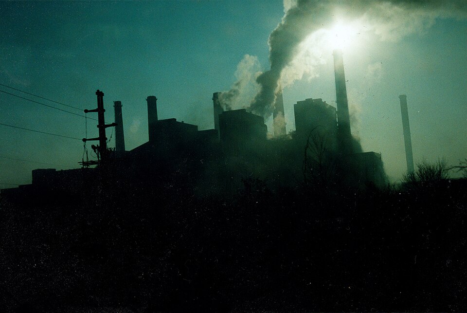 Industrial smokestacks emitting smoke into the sky