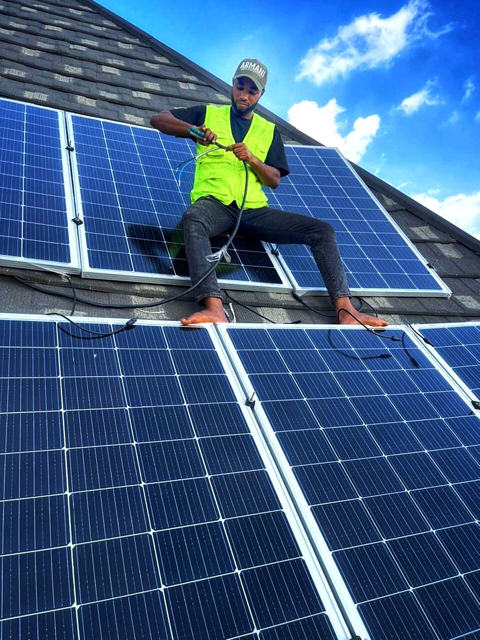 A solar panel installer at work in Nigeria